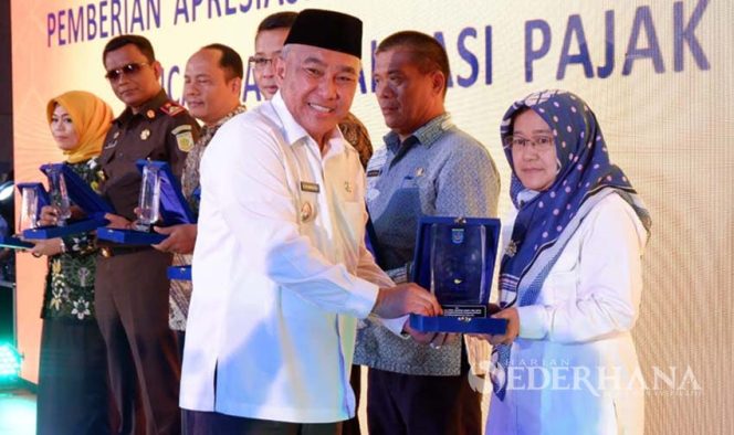 
					Wali Kota Depok, Mohammad Idris memberikan penghargaan kepada Wajib Pajak Teladan 2019.