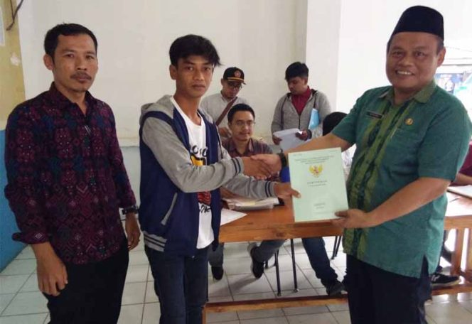 
					Lurah Pasir Putih, Ahmad Rifai (kanan) secara simbolis menyerahkan sertifikat PTSL.