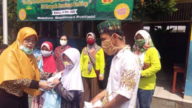 
					Euis Nurhayati, Kepala SDN Pondok Petir (Pontir) 01 secara simbolis menyerahkan santunan kepada yatim.